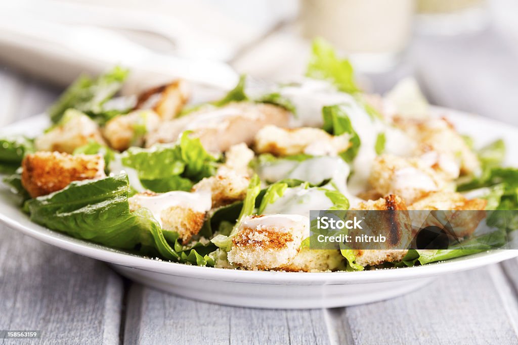 Caesar salad Caesar salad on wooden table Caesar Salad Stock Photo