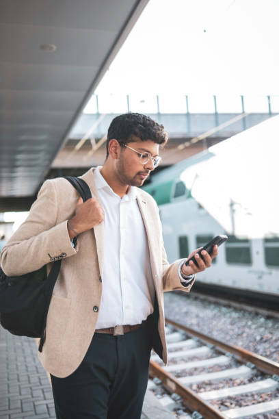 istock Millennial Indian businessman commuting for work. He is taking a train from the station . 1585632335