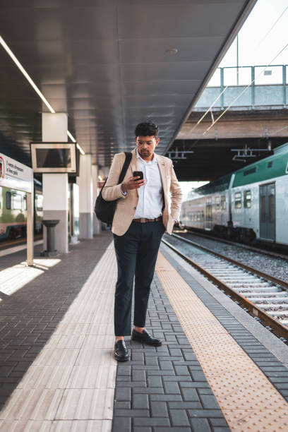 istock Millennial Indian businessman commuting for work. He is taking a train from the station . 1585632343