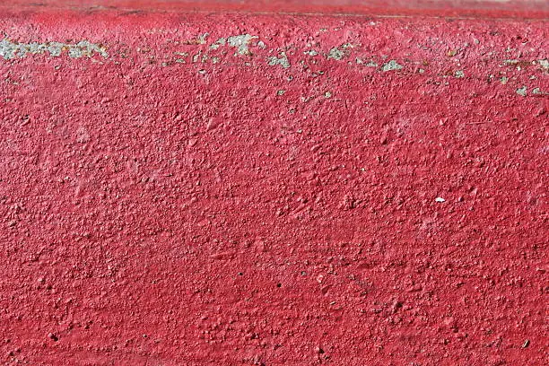 A close up of painted red curb says much more than "No Parking." The brilliant color comfortably ramps up the energy of whatever you choose to lay over the top of this pleasing background image while the left-side sheen gently urges the viewer's eyes toward the center of the image.