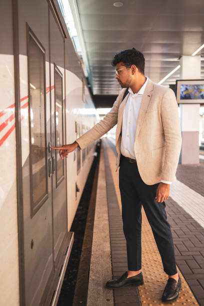 istock Millennial Indian businessman commuting for work. He is taking a train from the station . 1585633412