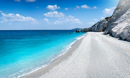 The impressive beach of Lalaria, Skiathos island, Sporades, Greece, with light gray pebble stones and turquoise, shining sea