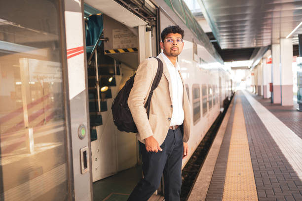istock Millennial Indian businessman commuting for work. He is taking a train from the station . 1585634231