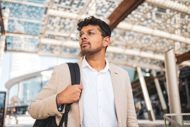 istock Millennial Indian businessman commuting for work. He is taking a train from the station . 1585637697