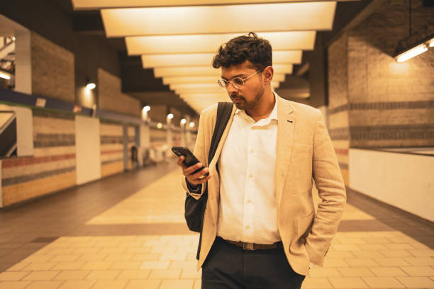 istock Millennial Indian businessman commuting for work. He is taking a train from the station . 1585639358