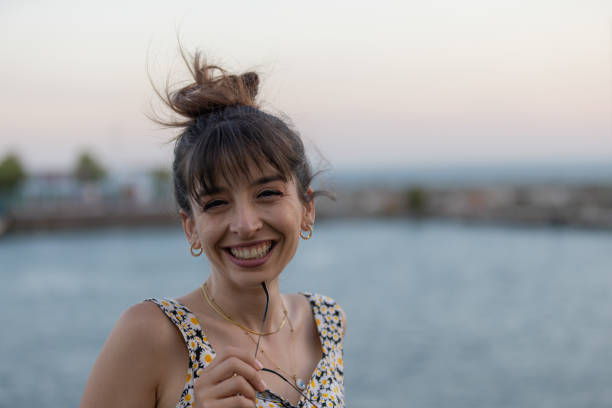 Young woman is traveling around city of Istanbul on ferry at sunset.