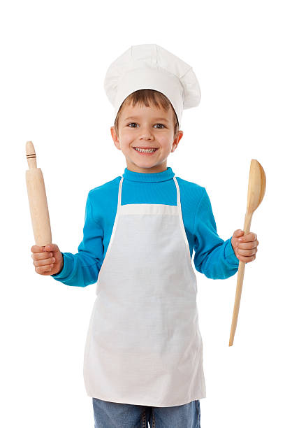 istock Young boy dressed in a chefs outfit with ladle and spoon 158568324