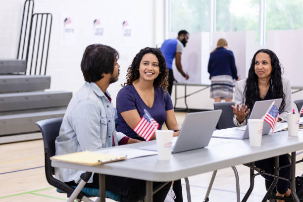 istock Registration volunteers sit and enjoy conversation while they wait for more voters to arrive 1585693446