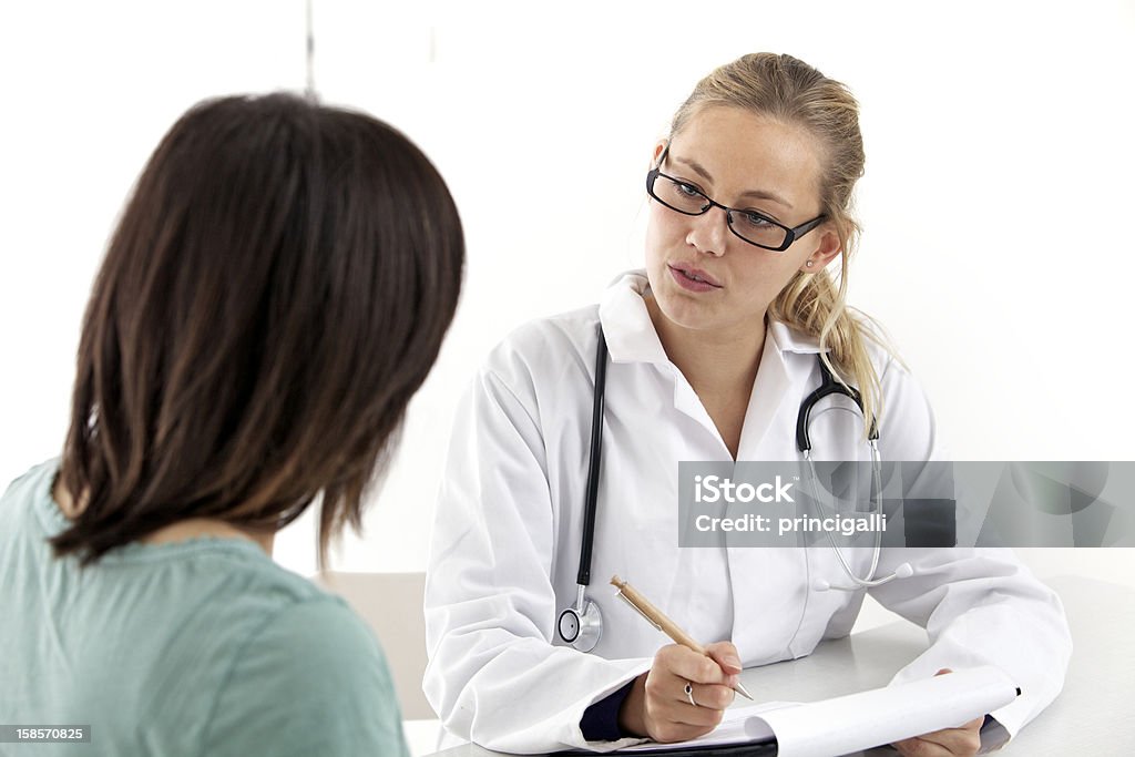 Doctor counseling Woman talks to doctor. Medical Clinic Stock Photo