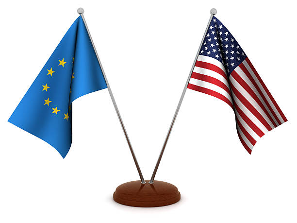 US and EU flags on a cracked surface, divided by a jagged line. The crack symbolizes potential trade tensions, notably the EU's reaction to US tariffs. This image can be used for articles on US-EU trade relations, covering tariffs, trade disputes, and transatlantic economic cooperation.