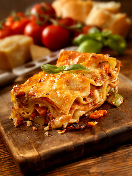 Lasagna Spring Authentic Italian Vegetarian Lasagna on a Cutting Board with Ingredients -Photographed on Hasselblad H3D2-39mb Camera side salad stock pictures, royalty-free photos & images