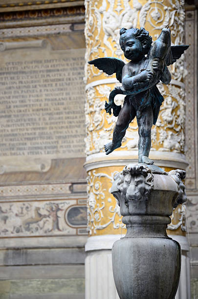 Porphyry Fountain (Putto with Dolphin) Porphyry Fountain by Verrocchio(c. 1435–1488) in Internal courtyard of Palazzo Vecchio, Florence, Italiy. fountain courtyard villa italian culture stock pictures, royalty-free photos & images