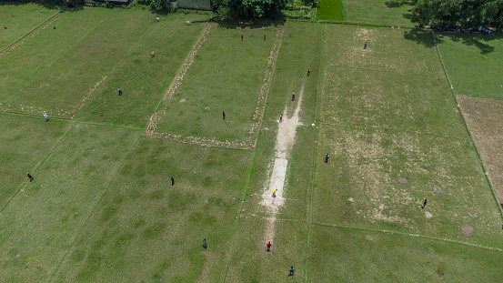 Despite the absence of a proper playing field, the children have come together and turned the fallow cropland into their cricket playground!