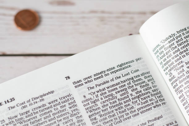 istock Lost coin parable verses in open holy bible book 1585739233
