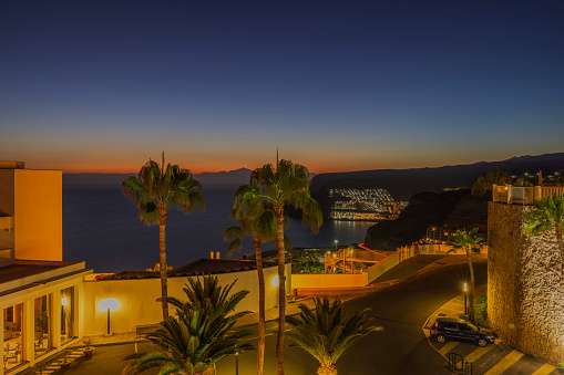 Gran Canaria, Spain. 08.01.2023. Beautiful exterior view of hotel at Gran Canaria on backdrop of sunset in Atlantic Ocean.