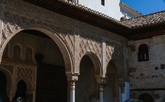 Granada,Spain - July 4, 2023: details of the coffered ceiling decorating the walls and arches inside the Alhambra.