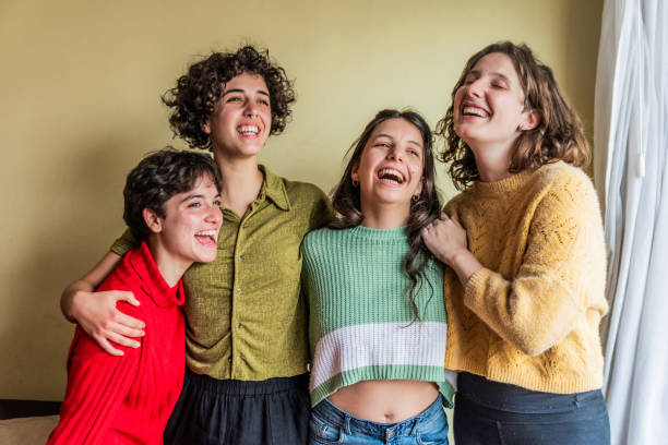 istock Female friends embracing while having fun at home 1585753594