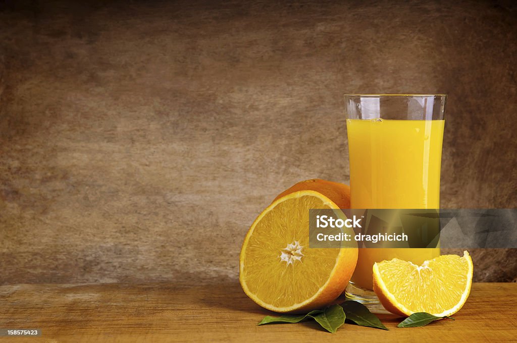 orange juice glass of orange juice and fruits with copy space against wooden background Citrus Fruit Stock Photo