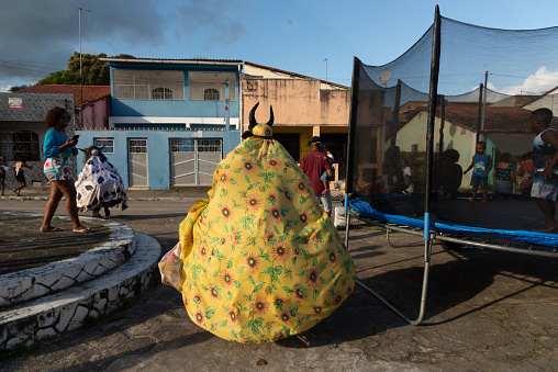 Santo Amaro, Bahia, Brazil - July 23, 2023: Cultural group Caretas de Acupe with people dressed as monsters is seen during a presentation in the streets of Acupe, Santo Amaro, Bahia.