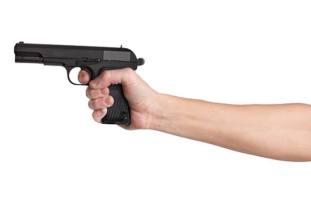 istock Gun in his outstretched hand of a man 158578934