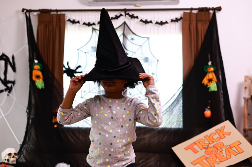 Adorable african american boy wearing Halloween costumes  standing  at home with decorate for a night party