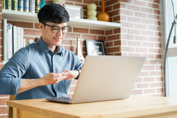 istock close up asian man make gesture hand of deaf sign language to teaching or learning from webinar in home for lifestyle concept 1585794788