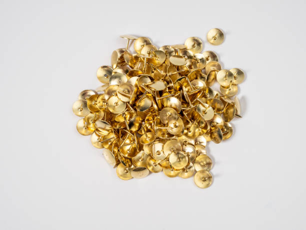 istock Pushpins of gold color on a white background. 1585806849