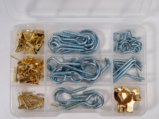 A set of different screws with a hook in a box on a white background.