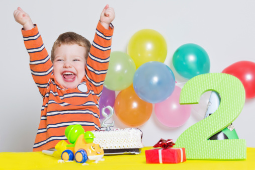Studio shot of two year old Caucasian boy celebrating second birthday