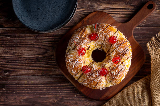 istock Sweet bread with pastry cream, coconut and cherry. 1585835710