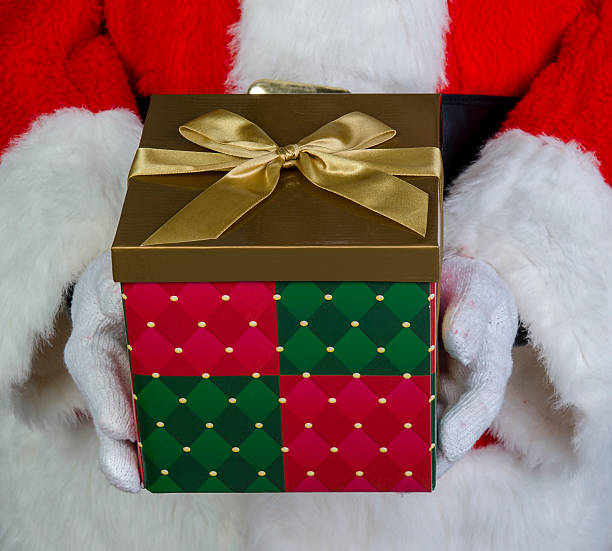istock Santa Claus holding a gift 158584688