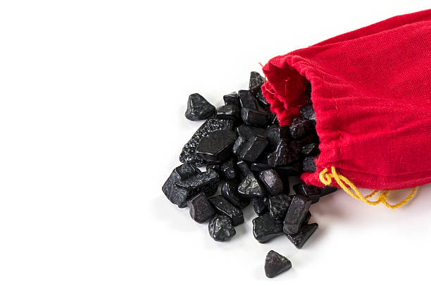 Bag of coal isolated on white Coal spilling out of a red sack isolated on white with copy space hard bituminous coal stock pictures, royalty-free photos & images