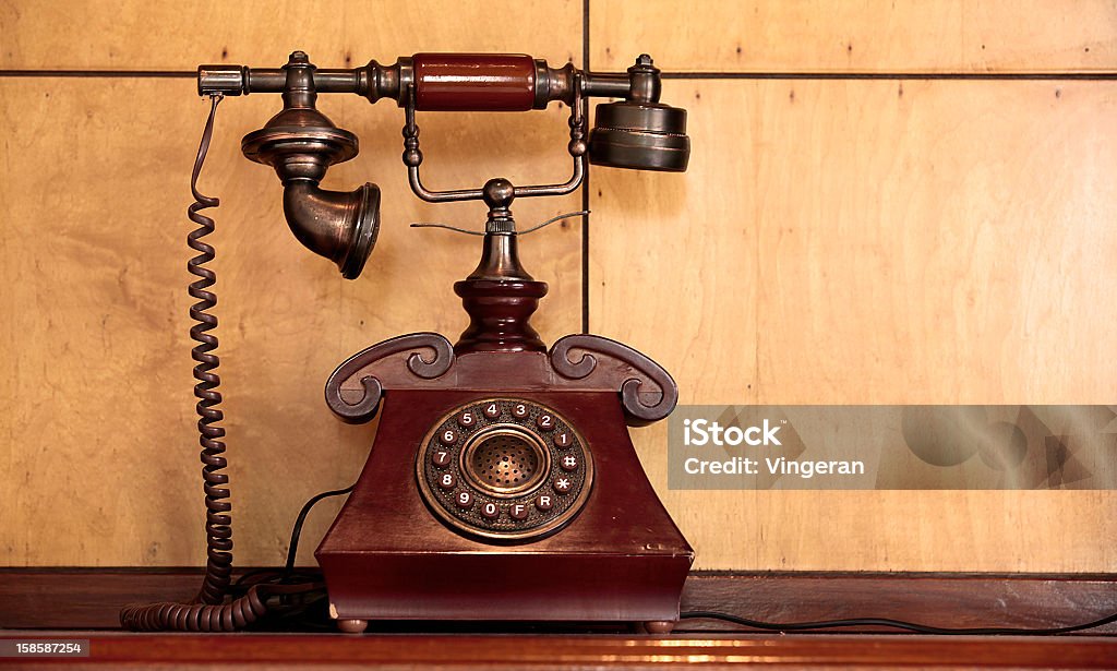 Antique Telephone An Old Style Telephone placed in front of a wooden wall Candlestick Phone Stock Photo