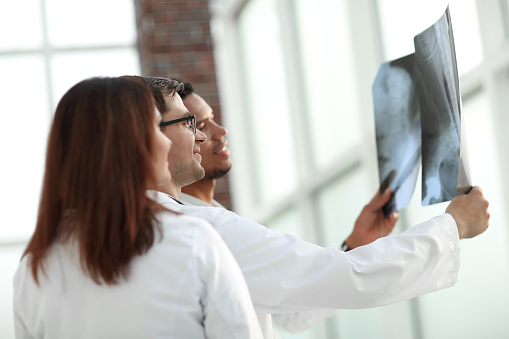 group of medical doctors discussing the patient's x-ray. the concept of health