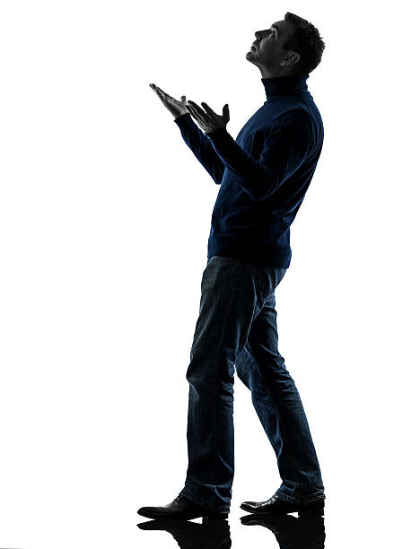 istock man looking up happy silhouette full length 158587424