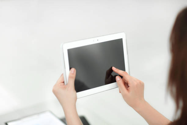 istock rear view. business woman using digital tablet 1585879112