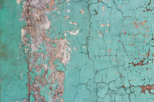 Photograph abstract background blue wall shabby weather cracked. Peeling paint.
