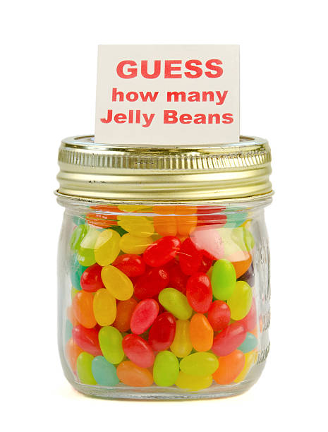 Guess how many jelly beans competition A pint mason jar of multicolored jelly beans with a printed card reading "GUESS how many Jelly Beans" on top jellybean stock pictures, royalty-free photos & images