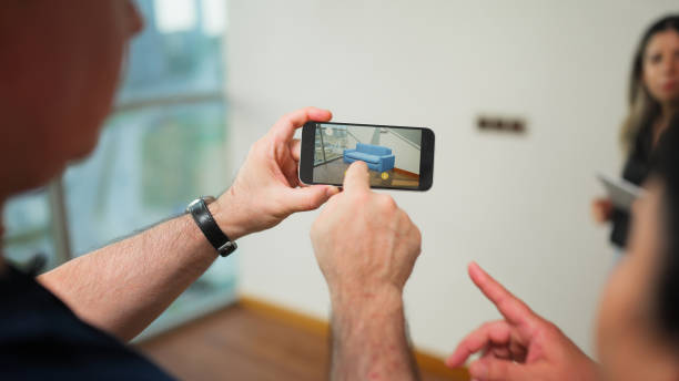 istock Senior couple using augmented reality technology to check furniture in house 1585897178