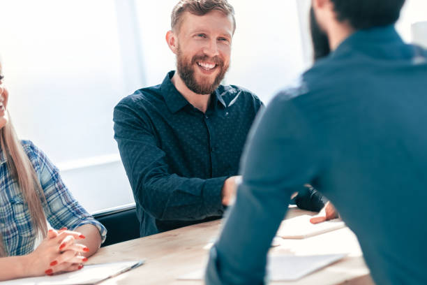 istock managers interview the applicant sitting at the office table. 1585899293