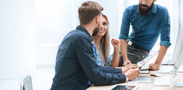 istock boss and business team discussing financial documents 1585901342