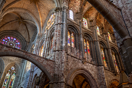 Interior detail of the cathedral of Avila, Castilla y Leon, Spain, with its gothic style and impressive vaults and colorful stained glass windows
