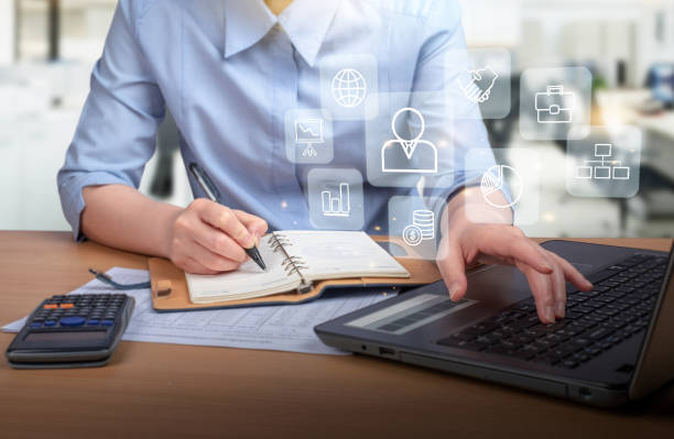 istock businesswoman  using smart phone with laptop and digital computer 1585933387