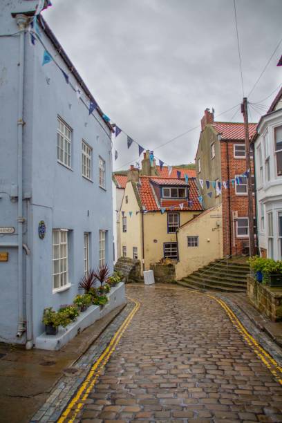 istock Road through Staithes village, Yorkshire, UK 1585969460