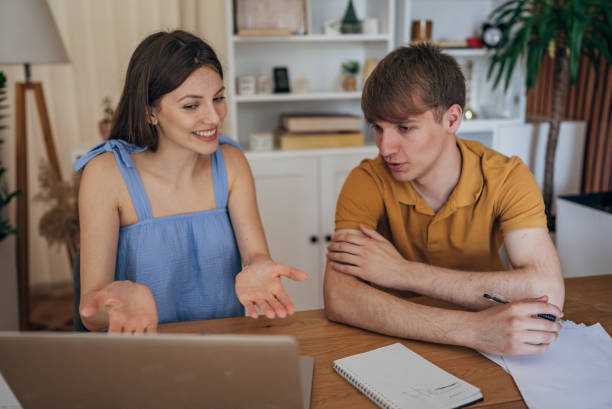 istock Couple studying together at home 1585978521