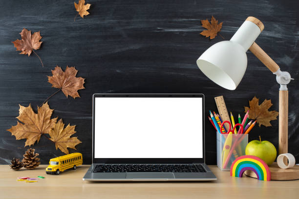 istock Dive into realm of virtual learning with this compelling top-down picture showcasing laptop and stationary on blackboard isolated backdrop. Customize the copy-space with text or promotional content 1585985969