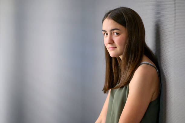 istock Young woman with blank expression standing in a corridor 1585992255