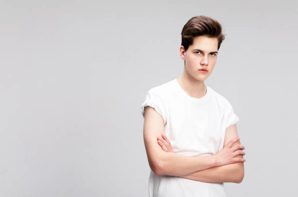 istock young man wear white t-shirt looking at camera on grey background 1586035205