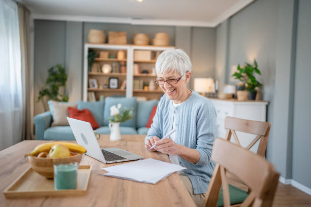 istock Senior caucasian woman use laptop computer at home for work 1586049604