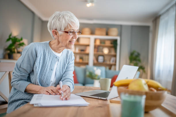 istock Senior caucasian woman use laptop computer at home for work 1586049606